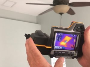 infrared camera showing heat coming from the HVAC during the blower door test of our net-zero project