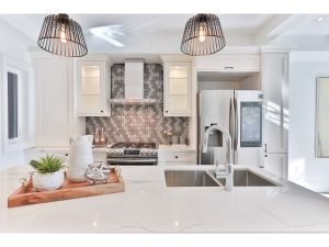 Photo of a brightly lit, modern kitchen in a new, energy-efficient house.