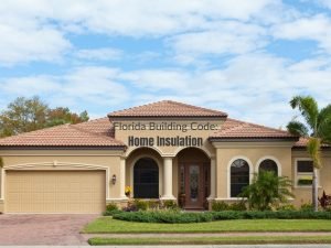 Photo of a tan stucco Florida home with a red tile roof and manicured landscape; caption "Florida Building Code: Home Insulation"