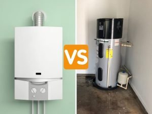 Side-by-side photo of a tankless water heater mounted on a wall and a heat pump water heater installed in a garage with the caption "versus"