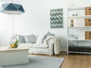 Photo of a comfortable modern living room decorated in white. Interior wall insulation contributes to indoor comfort.