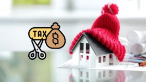 A picture of a little house wrapped in a warm hat made of yarn, with a tax money symbol being cut up to the left of it.