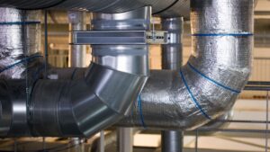 Air ducts in a home with metal-baked tape applied to prevent air duct leakage