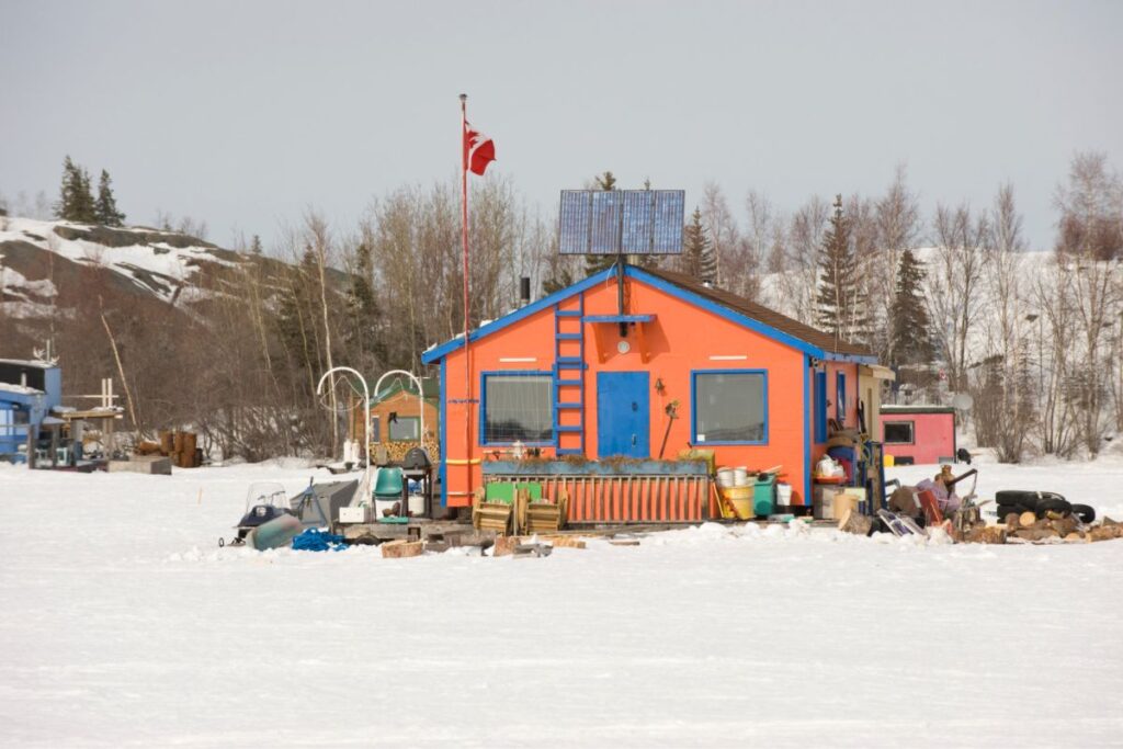 Front-facing view of an energy-efficient off-grid home in winter