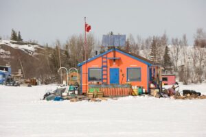 Front-facing view of an energy-efficient off-grid home in winter