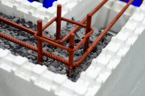 a closeup of the inside of insulated concrete form blocks with rocks in the middle of it