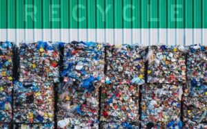 a pile of bundled recycled plastic stacked on each other, with the words Recycle written above it in the picture