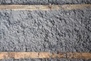 A closeup of cellulose insulation applied in a wall