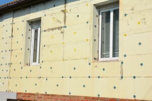 The exterior of a home under construction which has had exterior home insulation applied