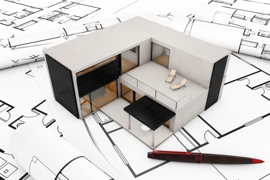 A model modular home resting on some floor plans