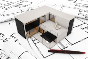 A model modular home resting on some floor plans