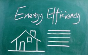 a green blackboard showing chaulk drawings of a house and the words Energy Efficiency drawn at the top as the title