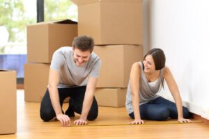 A couple uses a measuring tape to calculate the square footage of their home in order to correctly size an HRV.