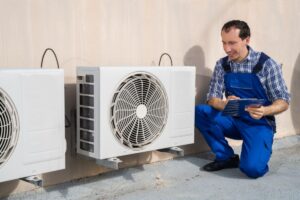 A technician checks the status of an energy recovery ventilator