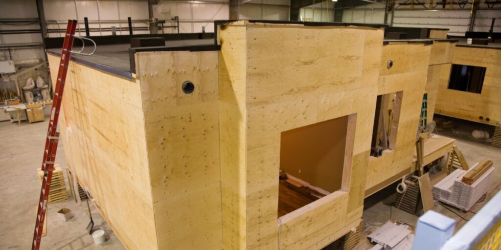 A modular home under fabrication in a warehouse