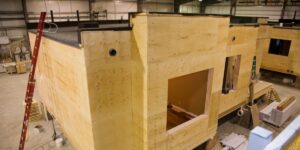 A modular home under fabrication in a warehouse