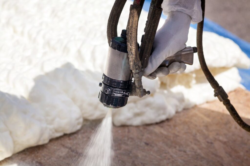 Spray foam insulation is applied with a spray gun