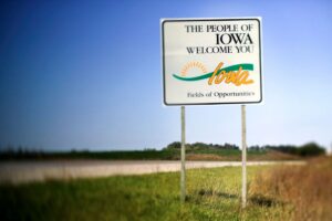 A sign at the stateline along the freeway welcomes visitors to Iowa