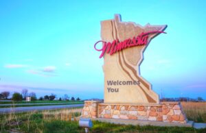 The Minnesota state sign along the freeway welcomes visitors to the state.