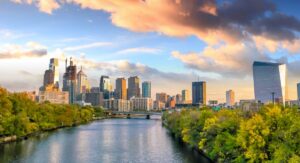 A view of downtown Philadelphia at sunset from a bridge above the Schuylkill river