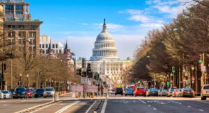 A downtown street level view of Washington, D.C., with the nation's capital building in the background