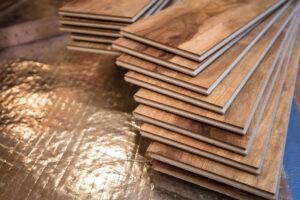 Closeup on the end of a stack of wood flooring panels ready to be installed