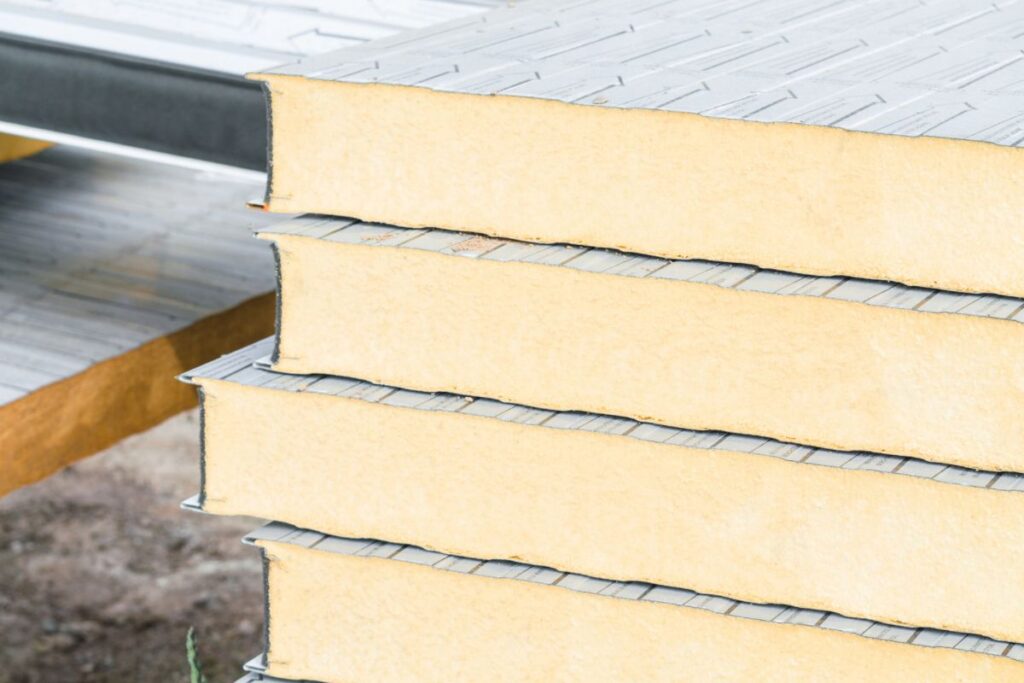 Closeup on the end grain of stacked pieces of polyiso radiant barrier foam board insulation