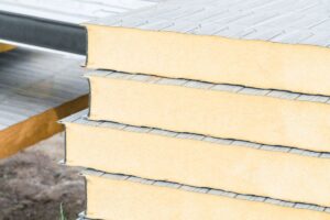 Closeup on the end grain of stacked pieces of polyiso radiant barrier foam board insulation