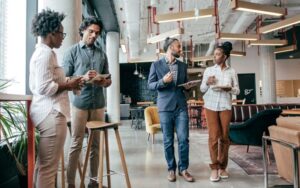 A group of team members in a business office talking business