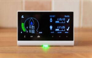 a monitor on the desk showing lots of solar and electricity home energy use calculations on the screen