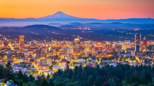 A downtown view of Portland, Oregon at sundown, with Mt. Hood in the background