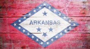 The state seal of Arkansas painted on distressed wood boards