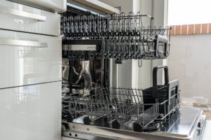 Closeup view of an open dishwasher in a kitchen