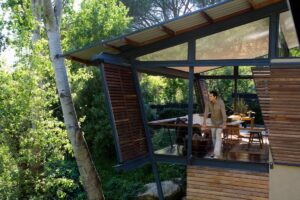 A homeowner peers off his deck through his eco-friendly windows