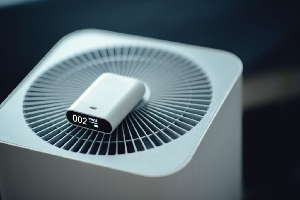 An air quality reading device sits atop a green home's ventilation system