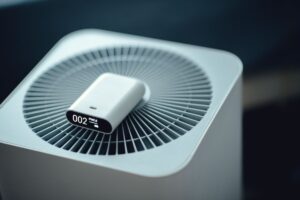 An air quality reading device sits atop a green home's ventilation system