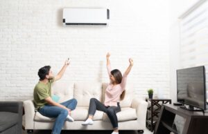 Homeowners sitting on their living room couch appreciate their ductless mini-split
