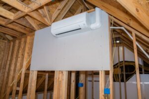 A ductless mini-split installed below the roofline ceiling on the second story of a home