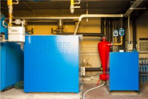 A blue geothermal heat pump in a basement used for geothermal cooling