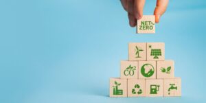 A graphic of fingers stacking blocks with images and text related to energy efficiency and net-zero homes
