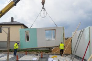 A crane lifting a modular home panel