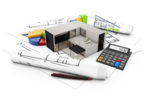A model modular home and a calculator on top of blueprints