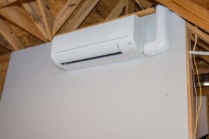 A mini-split condensor unit in a home's attic