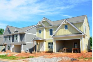 Front view of a new construction home with lumber still in the front yard