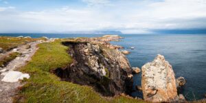 Cliffs along the Nova Scotia coastline that plateau with grass and a walking path on top