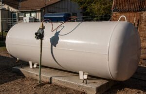 A propane tank outside a home connected to a propane furnace system