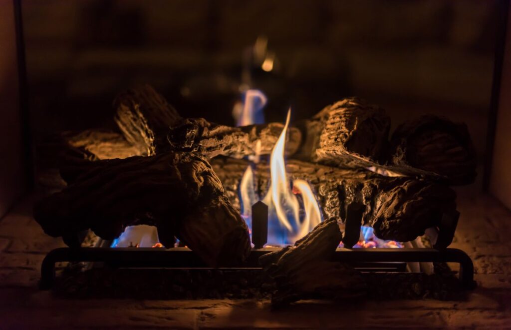 Closeup on a lit gas fireplace in a home