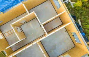 Overhead view looking down at a modular home partially-assembled on site