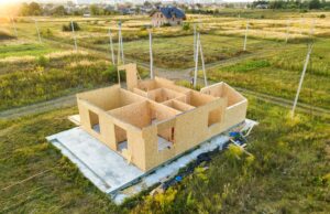The lower level of a modular home partially laid on it's foundation at the home site