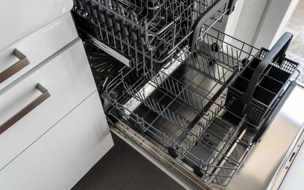 Close up view of an open, empty dishwasher
